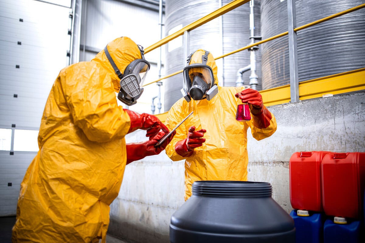 Pillar-SDS-Blog-two-workers-in-protective-suits-checking-chemical-3