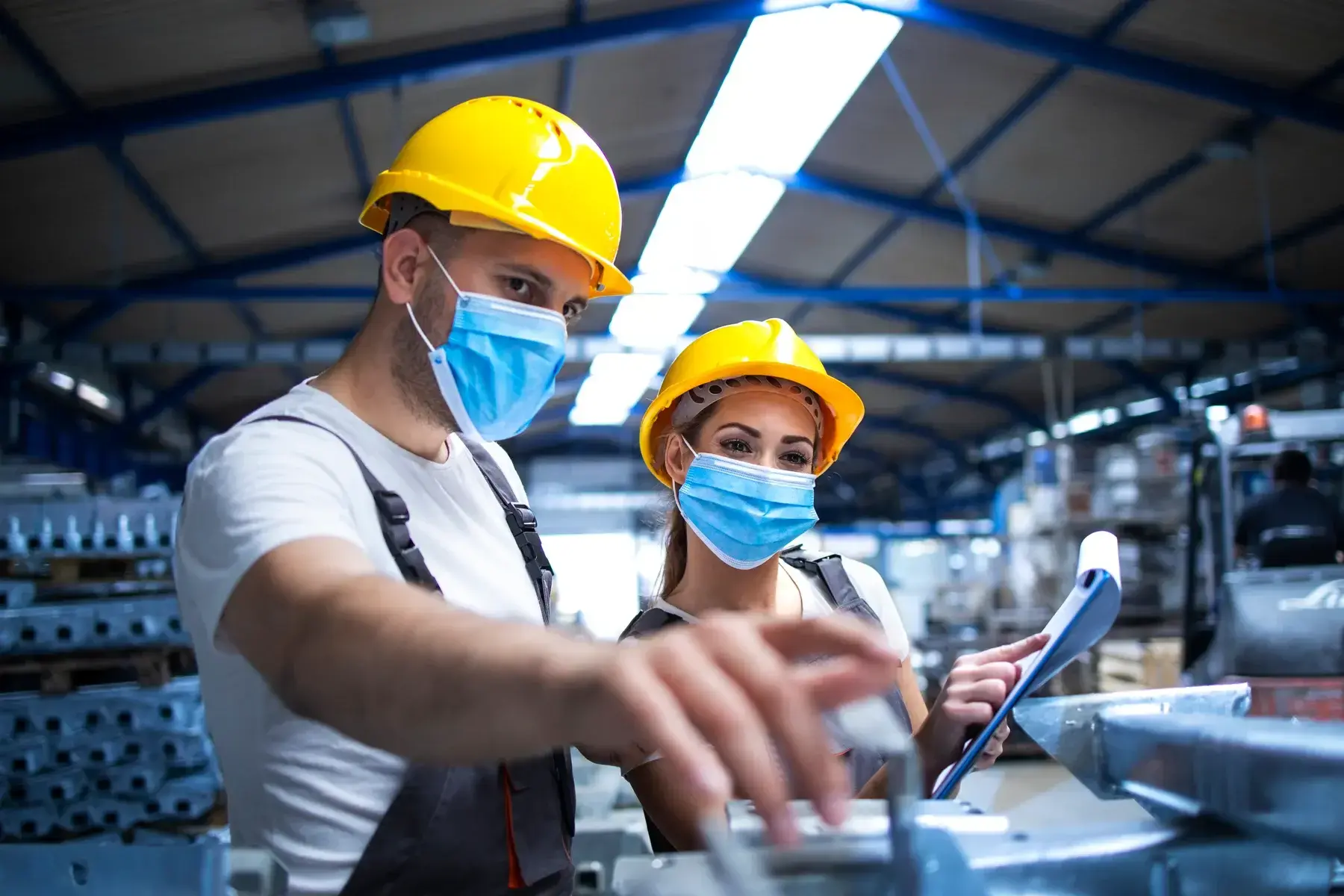 industrial-workers-with-face-masks-protected-against-corona-virus-discussing-about-metal-parts-factory-small-2