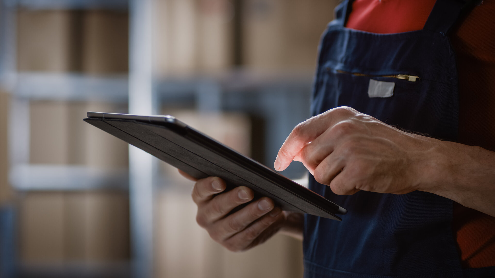 man in warehouse using tablet