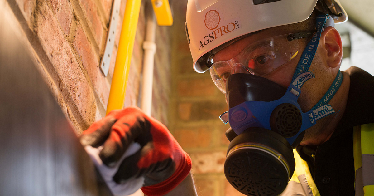 Person wearing respirator and working with chemicals