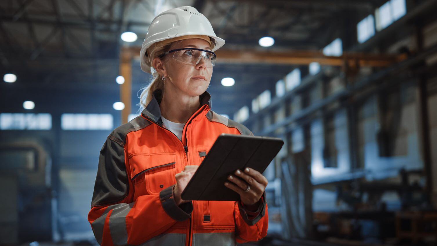 woman in hard hat holiding tablet