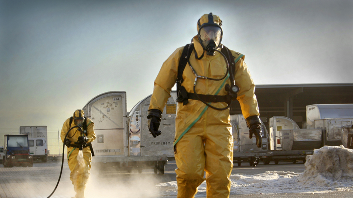 Two Workers Walking In Hazmat Suits